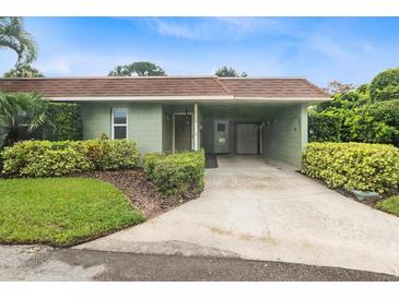 Charming single-story home featuring an attached carport and lush landscaping at 2200 Starboard, Winter Haven, FL 33881