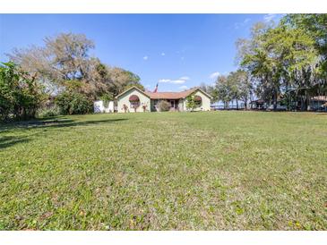Charming single-story home featuring a spacious lawn and inviting curb appeal at 9650 W Lake Marion Rd, Haines City, FL 33844