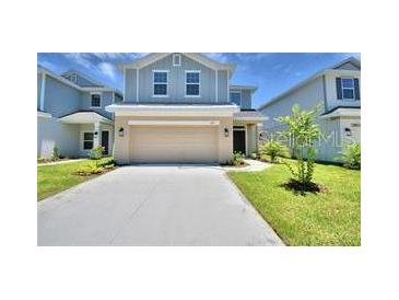 Charming two-story home with a well-maintained lawn and inviting curb appeal at 1476 Leamington Lane, Winter Haven, FL 33884
