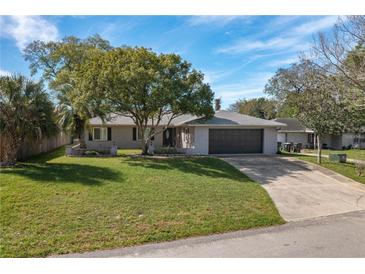Charming single-story home with a well-maintained front yard and a two car garage at 2014 Bardmoor, Winter Haven, FL 33884