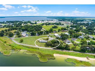 Aerial view of a single-story home with lake access and spacious lot at 405 W 4Th Ct, Frostproof, FL 33843