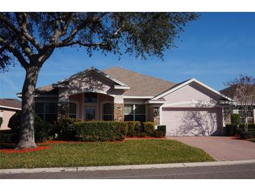 Attractive one-story home with a landscaped yard and a two-car garage at 3832 Traditions N Blvd, Winter Haven, FL 33884