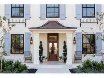 Elegant home featuring a covered entry, light blue shutters, and a refined front garden at 2300 Scenic N Hwy # 51, Lake Wales, FL 33898