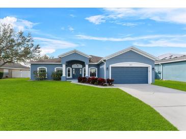 Charming one-story home with well-manicured lawn and beautiful landscaping at 2821 Sheldon St, Lakeland, FL 33813