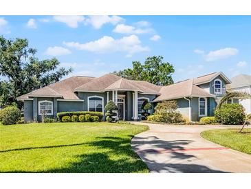 Charming single Gathering home featuring a well manicured lawn and circular driveway at 324 Hamilton Shores Ne Dr, Winter Haven, FL 33881