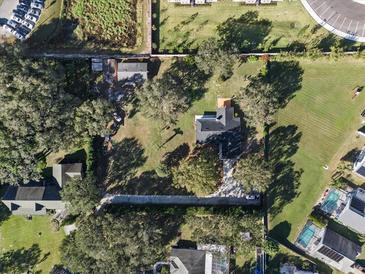 Expansive lot featuring lush greenery, mature trees, and a well-maintained home with a long driveway at 4570 Chambliss Rd, Winter Haven, FL 33884