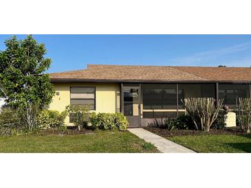 Charming single-story home featuring a screened porch, lush landscaping, and a well-maintained lawn at 16 Kendra Ct # 16, Winter Haven, FL 33880