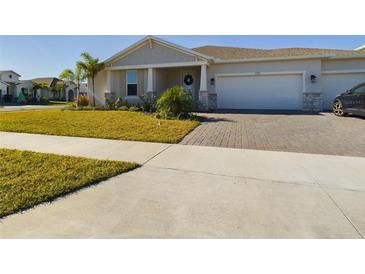 Two-story house with light gray siding, white columns, and a landscaped yard at 727 Annabell Ridge Rd, Minneola, FL 34715