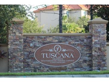 Tuscana condo community entrance with stone pillars and signage at 1371 Tuscan Ter # 3403, Davenport, FL 33896