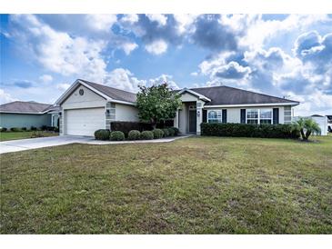 Single-story house with attached garage and well-manicured lawn at 1548 Normandy Heights Blvd, Winter Haven, FL 33880