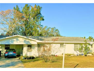 Ranch-style home with carport and spacious yard at 1865 4Th Se St, Winter Haven, FL 33880