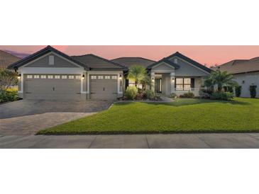 Two-story home with a two-car garage and a well-manicured lawn at 466 Lake Vista Dr, Auburndale, FL 33823