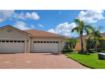 Charming single-story home with a three-car garage, paver driveway, and lush landscaping at 1649 Linz Ct, Winter Haven, FL 33884