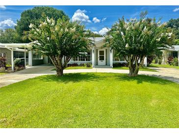 Attractive single-story home with well-manicured lawn and mature landscaping at 1663 W Lake Cannon Nw Dr, Winter Haven, FL 33881