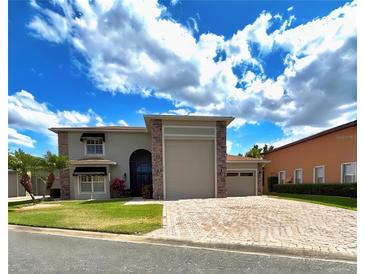 Charming two-story home with a brick driveway and well-manicured lawn at 4193 Limerick Dr, Lake Wales, FL 33859
