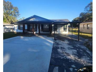 Cute one-story home features a covered porch and carport at 916 25Th Nw St, Winter Haven, FL 33881