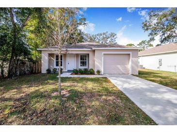 Newly built home with a landscaped yard and driveway at 124 A St, Haines City, FL 33844