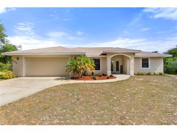 Charming single-story home with a two-car garage and a well-maintained, drought-resistant landscaped front yard at 2772 Indian Pipes Trl, Frostproof, FL 33843