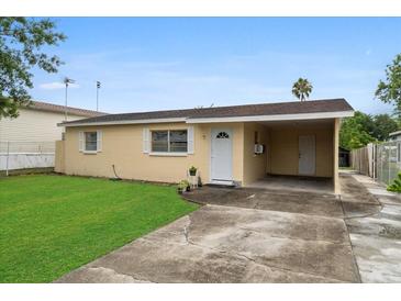 Ranch-style home with carport and well-maintained lawn at 1330 Skyview Blvd, Lakeland, FL 33801