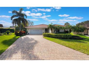 Charming single Gathering home featuring a paver driveway and mature landscaping at 768 Canberra Rd, Winter Haven, FL 33884