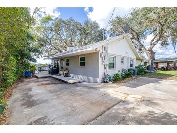 Charming single-story home featuring a spacious driveway and mature trees providing ample shade at 1048 Sunset Trail, Babson Park, FL 33827