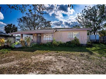Charming single-story home with a classic front porch and mature landscaping at 115 Jefferson St, Lake Wales, FL 33859