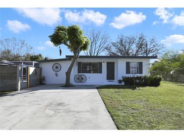 Charming single-story home with a well-manicured lawn and mature trees at 1817 Mckeown Ave, Haines City, FL 33844