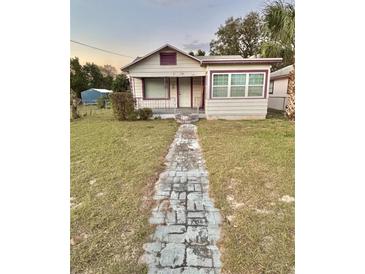 Charming bungalow with a stone walkway leading to the front porch at 216 Dorsett Ave, Lake Wales, FL 33853