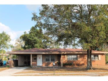 Charming single-story brick home with a covered carport and mature landscaping in the front yard at 807 S 1St St, Lake Wales, FL 33853