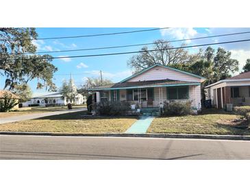 Charming single Gathering home featuring a cozy front porch and well-maintained lawn at 201 Dr J A Wiltshire W Ave, Lake Wales, FL 33853