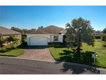 Charming single-story home featuring a brick driveway, well-manicured lawn, and a two-car garage at 3834 Bedford Ave, Winter Haven, FL 33884