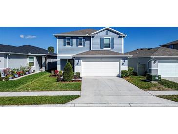 Charming two-story home featuring a well-maintained lawn and a two-car garage at 578 Preserve Pointe Blvd, Davenport, FL 33837