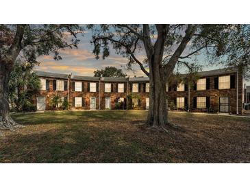 Charming brick townhomes featuring black shutters, white doors, and a spacious common area at 5850 Cypress Gardens Blvd # 206, Winter Haven, FL 33884
