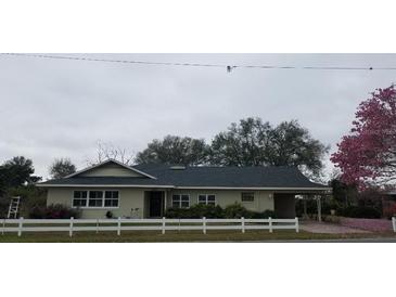 Charming single-story home with white picket fence and mature landscaping at 3065 E Central Ave, Bartow, FL 33830