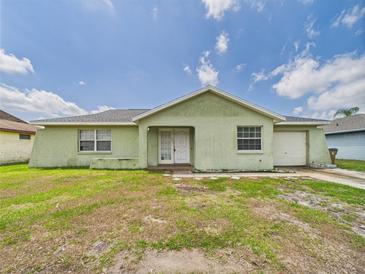 Single Gathering home showing the exterior, front yard and driveway on a sunny day at 91 W Cedarwood Cir, Kissimmee, FL 34743
