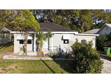 Charming single-story home with a well-maintained lawn, and a welcoming front porch at 1328 3Rd Ne St, Winter Haven, FL 33881