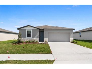 Charming single-Gathering home with a well-manicured lawn and a two-car garage at 1340 Oak Valley Drive, Auburndale, FL 33823