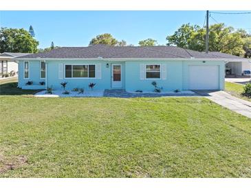 Charming light blue single-story home with a well-maintained lawn and tidy, decorative landscaping at 1530 S Lake Howard Dr, Winter Haven, FL 33880