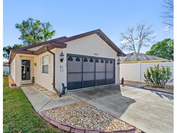 Charming single Gathering home featuring a well-maintained lawn and driveway at 1822 Nicaragua Way, Winter Haven, FL 33881