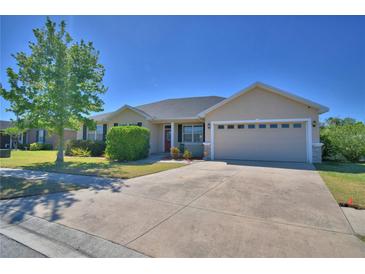 Lovely single-story home with a well-manicured lawn, neutral stucco exterior, and two-car garage at 2110 Saddlewood Dr, Bartow, FL 33830