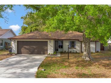 Charming single story home with a brown shingle roof, well-manicured lawn, and two car garage at 3323 Fox Ridge Dr, Winter Haven, FL 33884