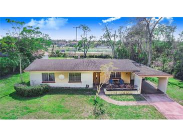 Charming single-story home featuring a well-maintained lawn and covered carport at 352 W Graham Park Dr, Haines City, FL 33844