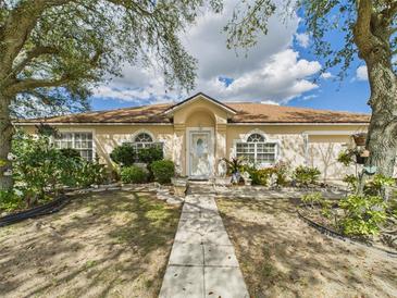 Charming single story home featuring a well-maintained lawn, mature trees, and a light-colored facade at 3690 Wellington Pl, Bartow, FL 33830