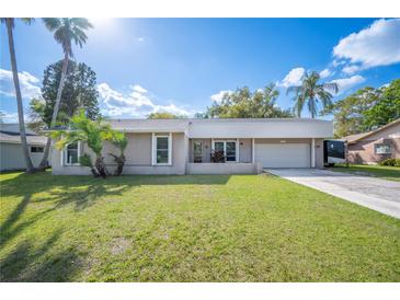 Charming single-story home with a well-maintained lawn and mature palm trees, perfect for Florida living at 5115 Woodgreen Ln, Lakeland, FL 33811