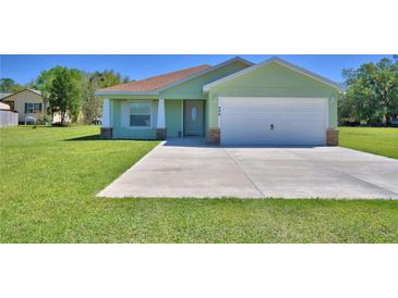 Charming one-story home with a well-manicured lawn and a spacious two-car garage at 990 Brooke Rd, Fort Meade, FL 33841