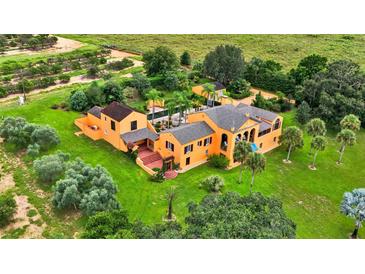 Stunning aerial view of a custom home with lush landscaping and a private pool at 2300 N Scenic Hwy # 56, Lake Wales, FL 33898