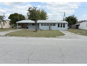 Charming single-story home with gray siding and a well-maintained front lawn at 253 Walter Ave, Frostproof, FL 33843