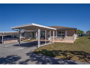 Charming single-story home with a covered carport and lovely landscaping, perfect for relaxed outdoor living at 398 Winter Ridge Blvd # 398, Winter Haven, FL 33881