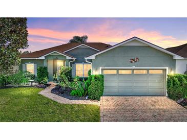 Charming single-story home with lush landscaping, brick driveway and a warm, inviting ambiance at 4485 Turnberry Ln, Lake Wales, FL 33859