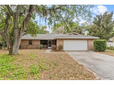 Charming brick home with a well-maintained lawn and mature trees providing ample shade at 4615 Reynosa Sw Dr, Winter Haven, FL 33880